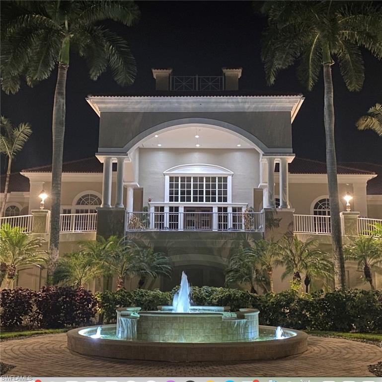 4630 Winged Foot Court, Unit 202 Naples, FL 34112 - Photo 27 of 32 Back of house at twilight featuring stucco siding
