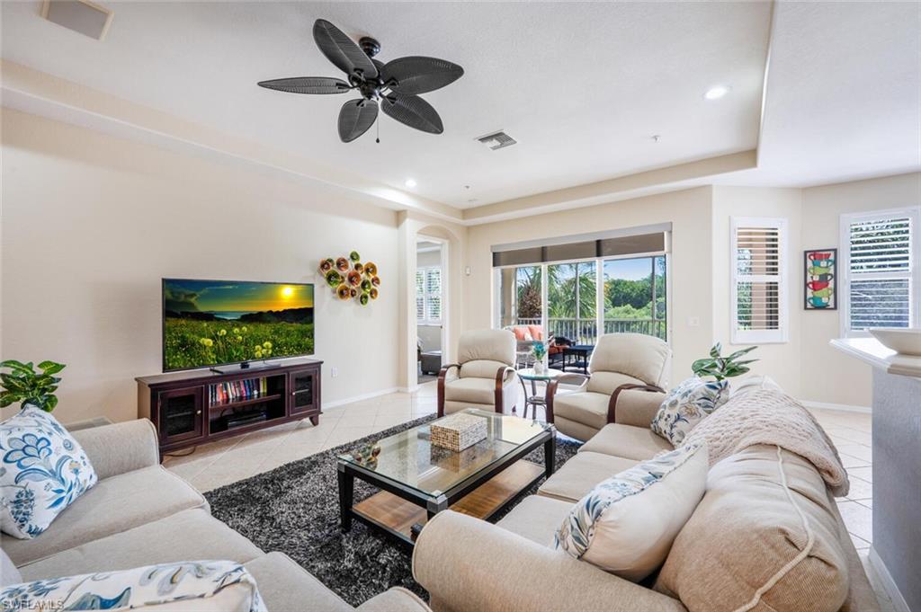4630 Winged Foot Court, Unit 202 Naples, FL 34112 - Photo 4 of 32 Living area featuring baseboards, visible vents, a ceiling fan, and tile patterned flooring
