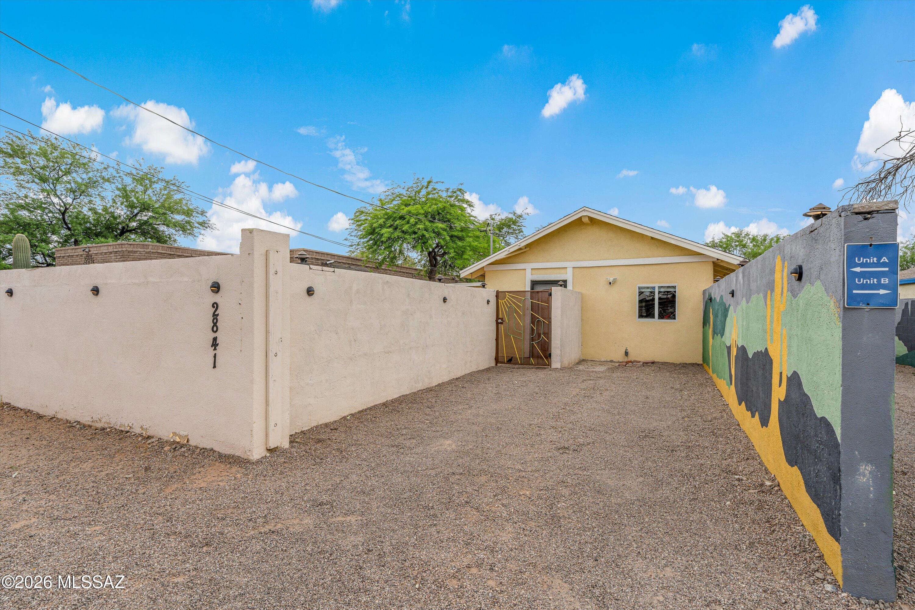 2841 North Richey Boulevard Tucson, AZ 85716 - Photo 2 of 30 a view of a house with a yard and garage