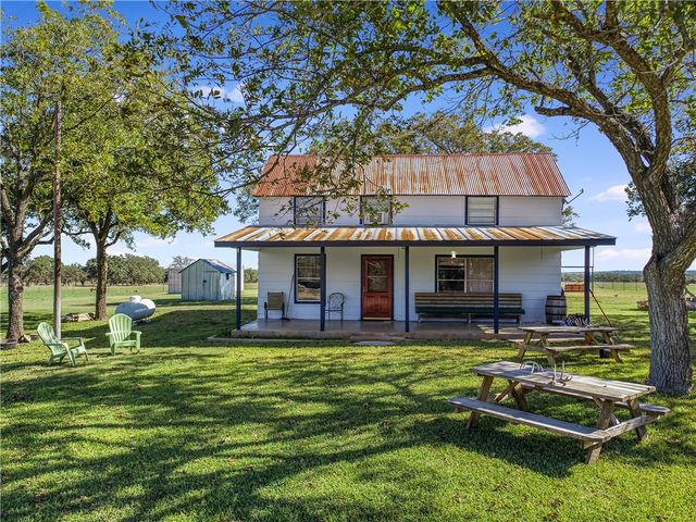 a view of a house with a yard porch and sitting area