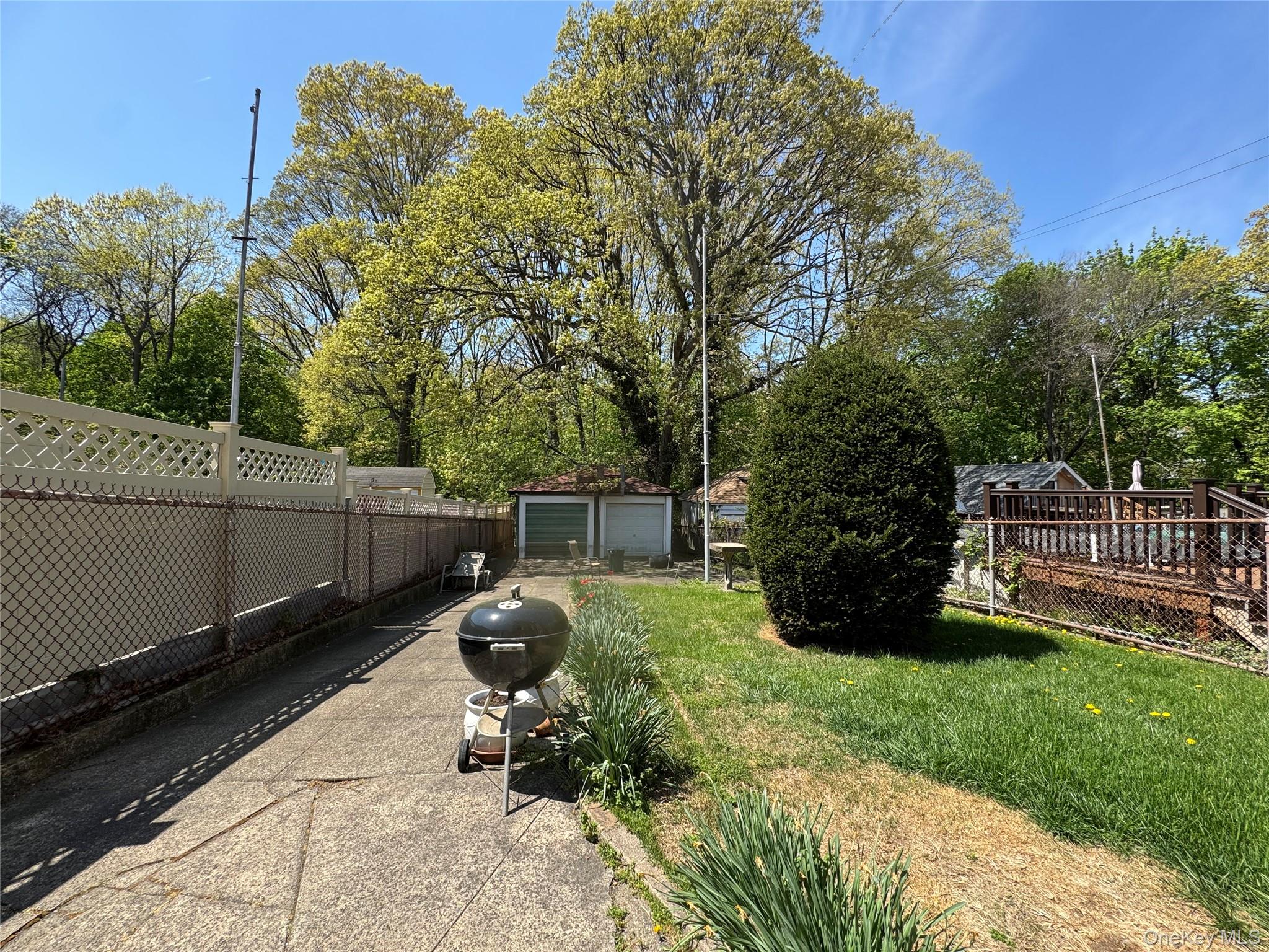 82-72 88th Place Queens, NY 11421 - Photo 4 of 26 a backyard of a house with lots of green space