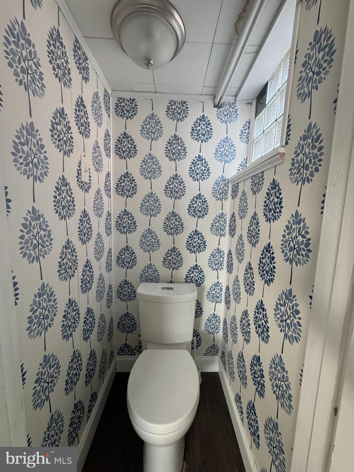 4215 Lansing Street Philadelphia, PA 19136 - Photo 12 of 14 a white toilet sitting next to a shower curtain