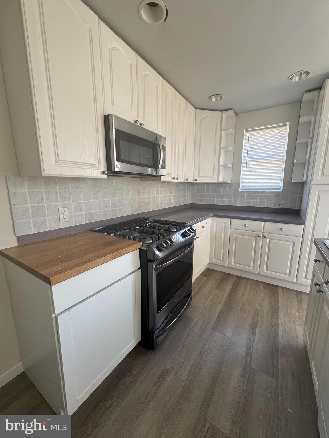 4215 Lansing Street Philadelphia, PA 19136 - Photo 4 of 14 a kitchen with stainless steel appliances white cabinets granite counter tops and a hard wood floors