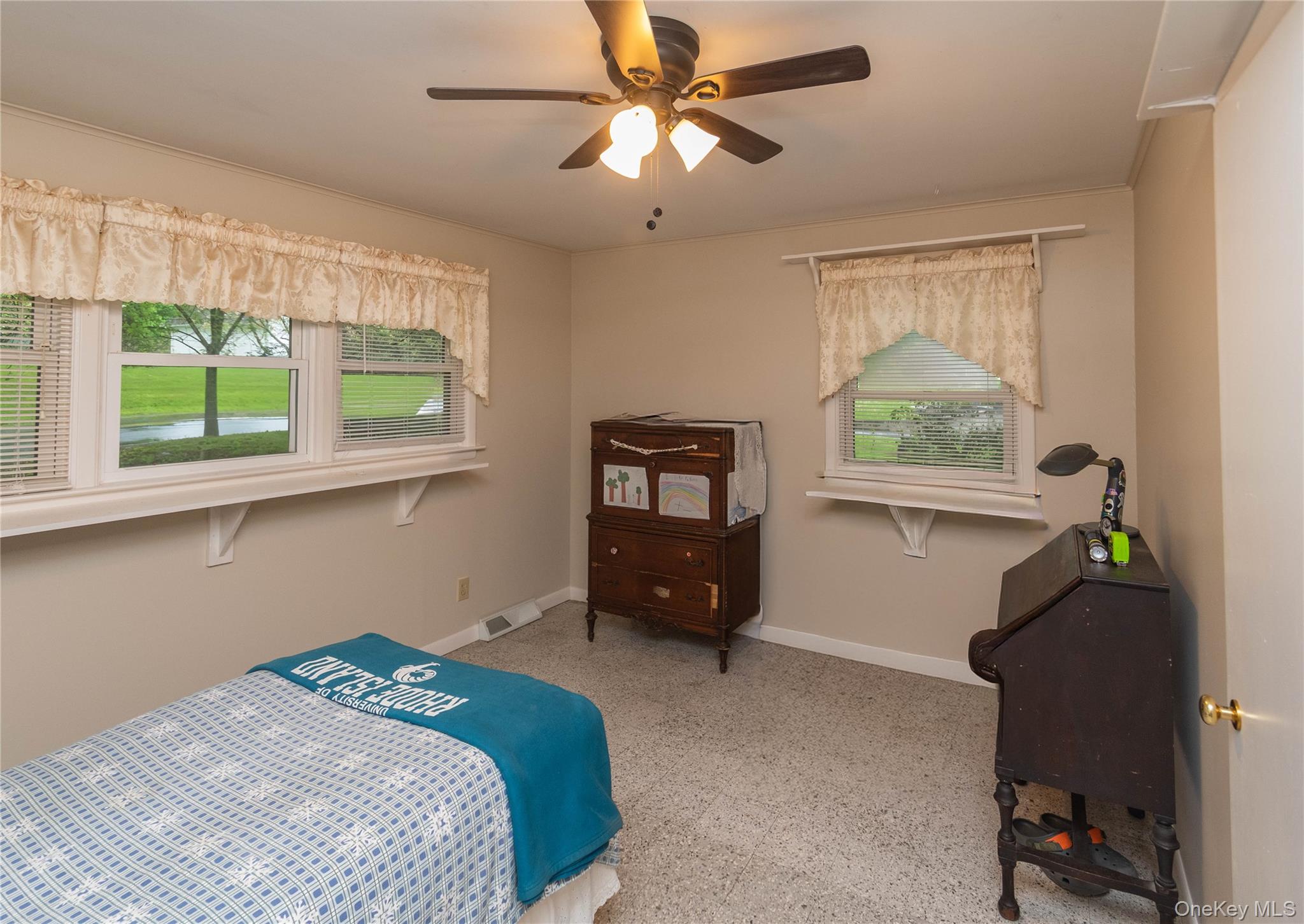 543 Dosen Road Middletown, NY 10940 - Photo 16 of 25 Neutral wall paint, two windows with blinds, ceiling fan with light fixture, light-toned carpet, and white baseboards