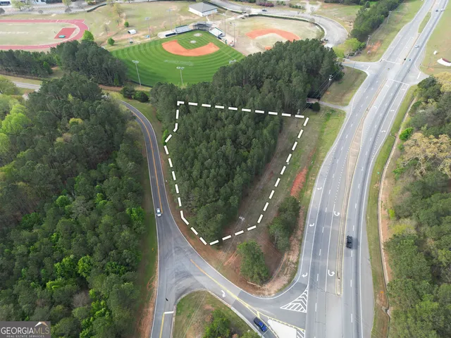 an aerial view of a residential houses with outdoor space and swimming pool