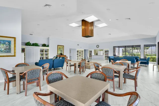 a living room with furniture kitchen view and a flat screen tv