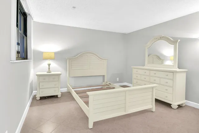 a room with a bed and a dresser