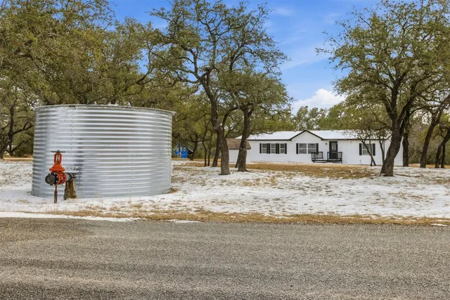 a view of a house with a snow in the yard