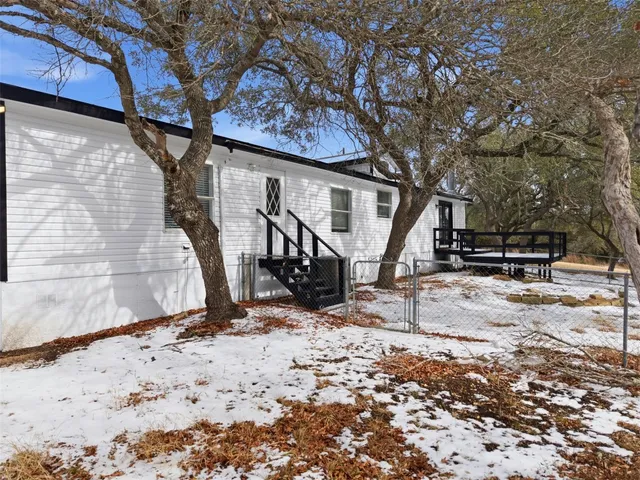 a view of a backyard with a tree
