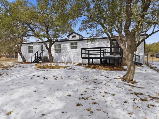 a view of a house with snow on the tree