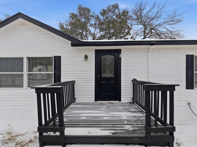 a kitchen with stainless steel appliances granite countertop a sink a stove a refrigerator and island with wooden floor