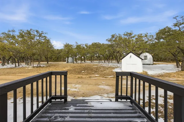 a large kitchen with stainless steel appliances granite countertop a sink a stove and a refrigerator