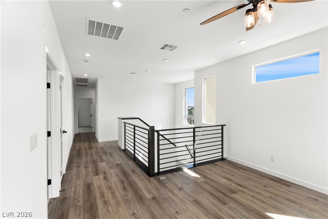 633 Infinity Rdg Street Las Vegas, NV 89138 - Photo 14 of 36 Hall featuring an upstairs landing, dark wood-style flooring, and recessed lighting