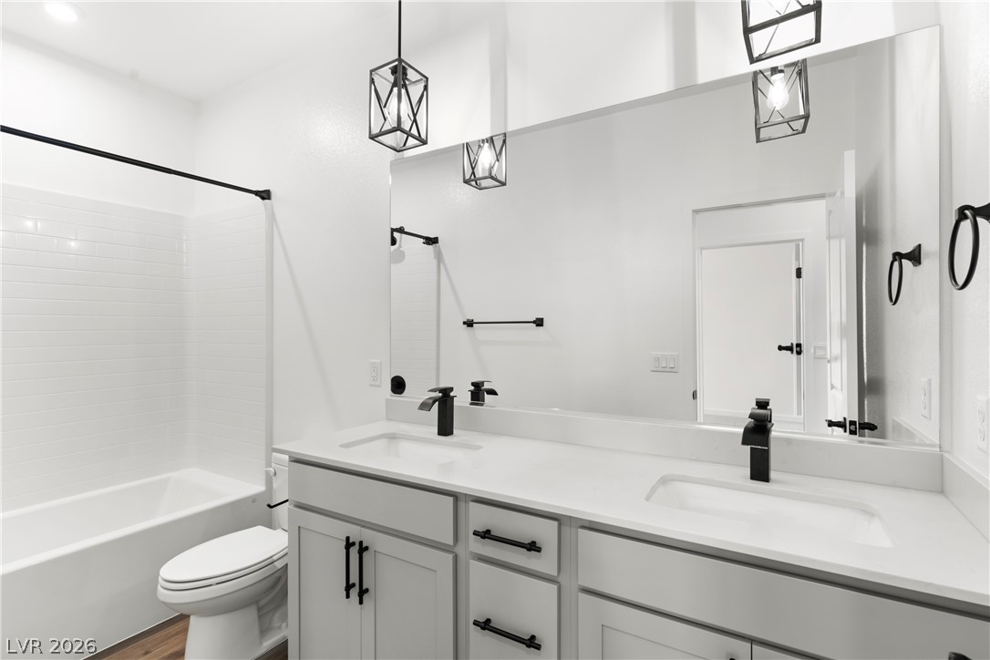 633 Infinity Rdg Street Las Vegas, NV 89138 - Photo 18 of 36 Full bath with double vanity, shower combination, and wood finished floors