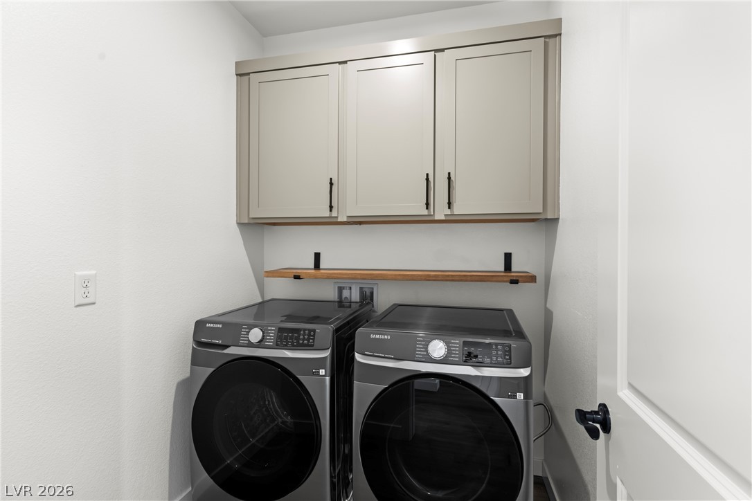 633 Infinity Rdg Street Las Vegas, NV 89138 - Photo 19 of 36 Laundry area featuring cabinet space and washer and dryer