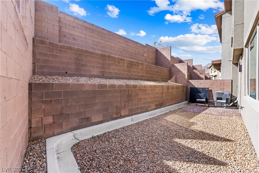 633 Infinity Rdg Street Las Vegas, NV 89138 - Photo 23 of 36 Fenced backyard with a patio