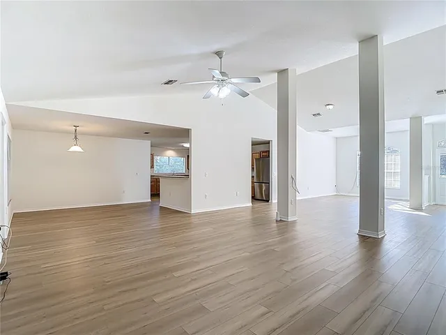 a kitchen with a stove and wooden floor