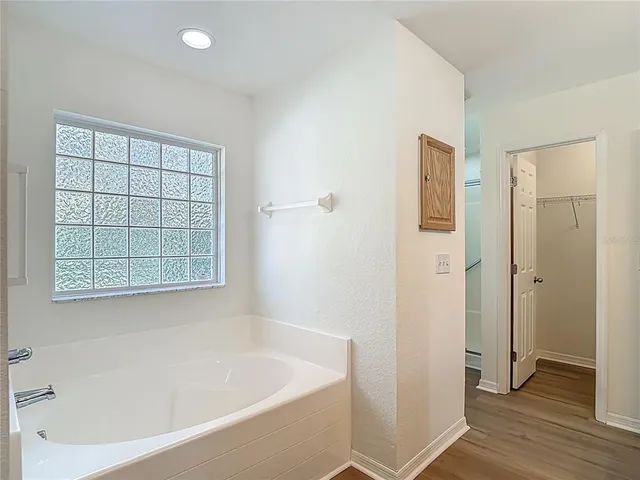 a view of a room with wooden floor and closet