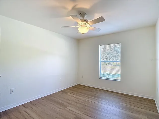 a view of yard with large trees