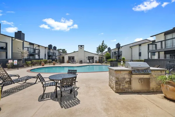 a view of a house with swimming pool outdoor seating