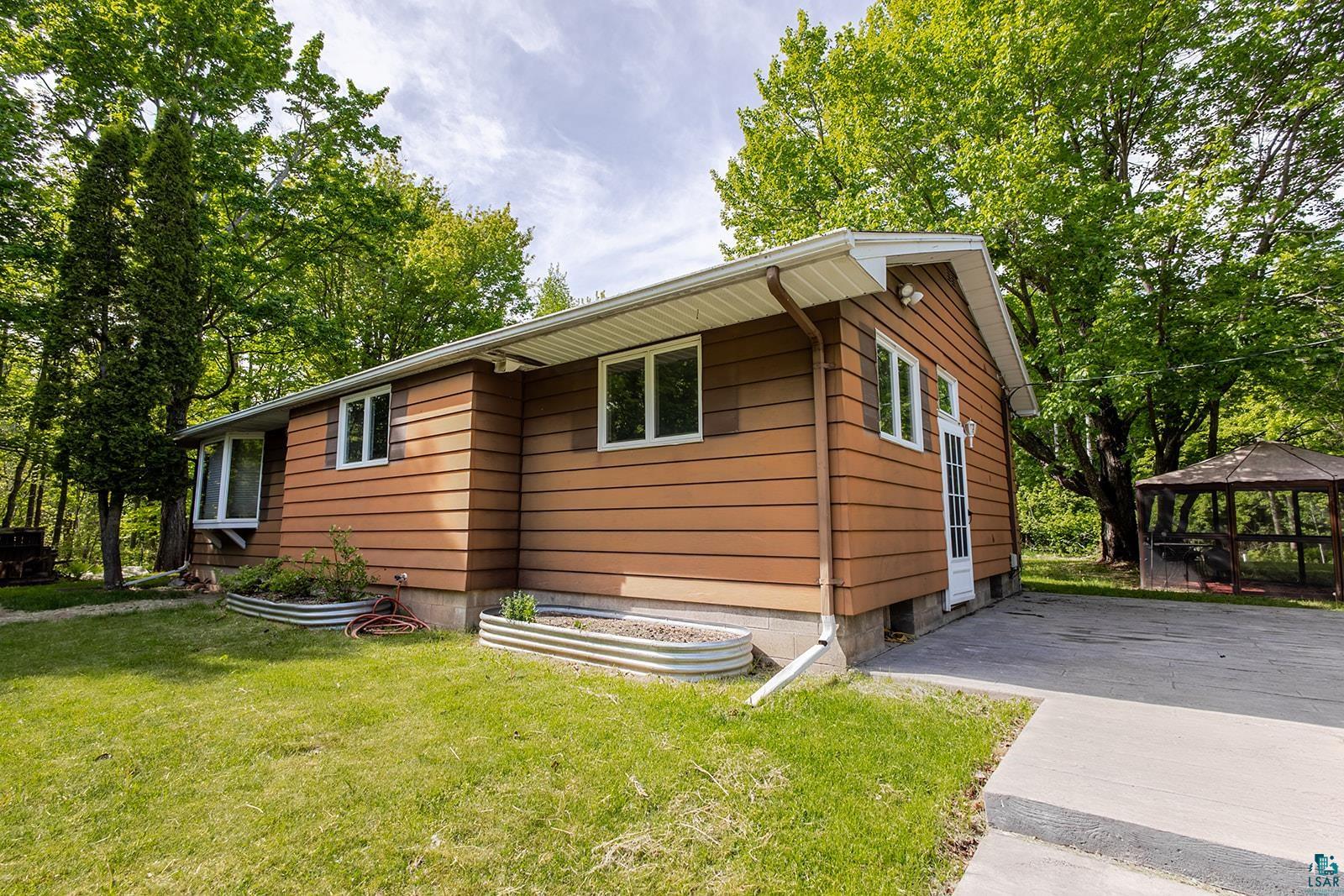 7045 Morris Thomas Road Cloquet, MN 55720 - Photo 2 of 28 Single-story residence featuring brown horizontal siding and white trim