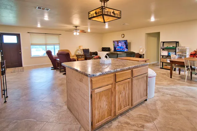 a very nice looking open kitchen with stainless steel appliances