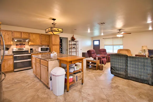 a spacious bathroom with a double vanity sink toilet and shower