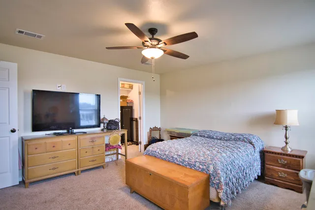 a bedroom with a bed dresser and a window