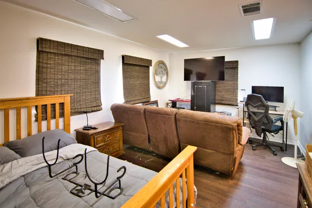 a living room with furniture wooden floor and a flat screen tv
