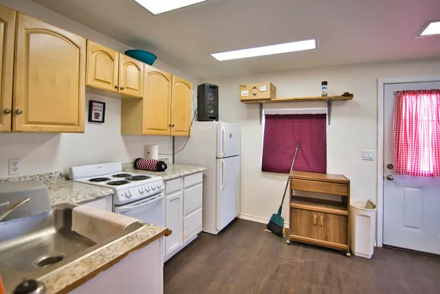 a kitchen with stainless steel appliances granite countertop a stove a sink and a refrigerator