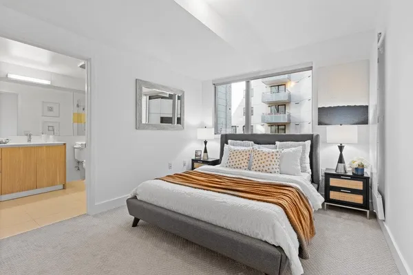 a bedroom with a bed and a lamp
