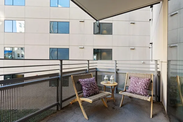 a view of a chairs and table in the back yard