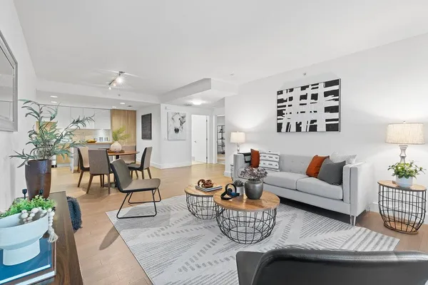 a living room with furniture and wooden floor
