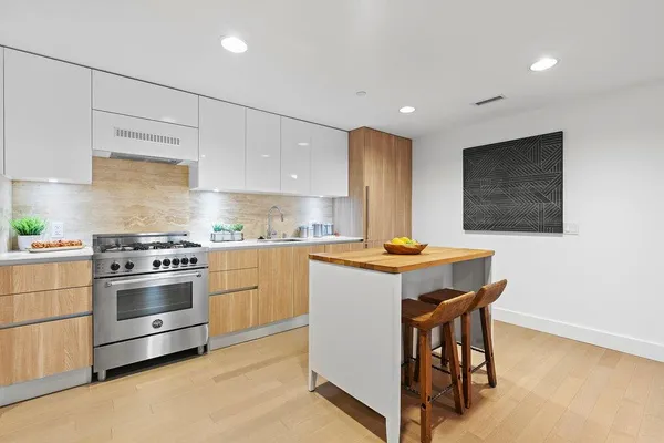 a kitchen with a stove a sink and a refrigerator