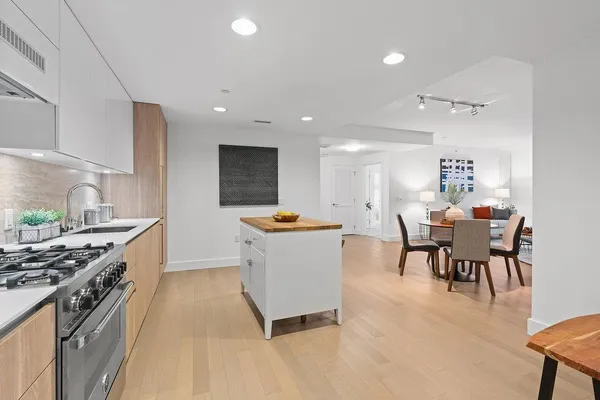 a large kitchen with a table and chairs in it