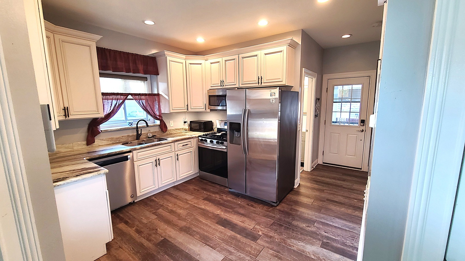 405 North Center Street Plano, IL 60545 - Photo 8 of 35 a kitchen with stainless steel appliances a refrigerator and a stove top oven