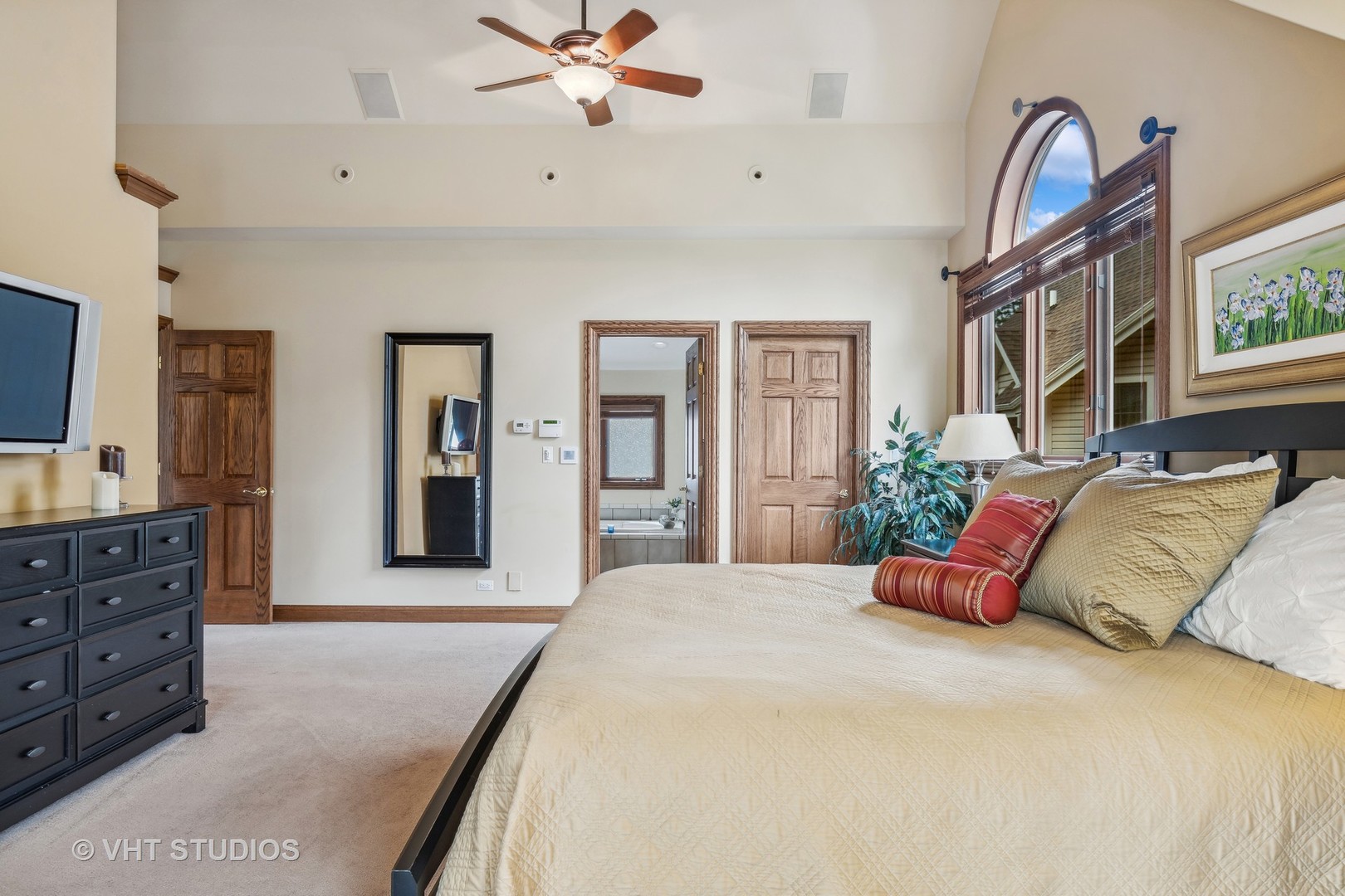 37131 North Stanton Point Road Ingleside, IL 60041 - Photo 13 of 28 a bedroom with a large bed and a chandelier