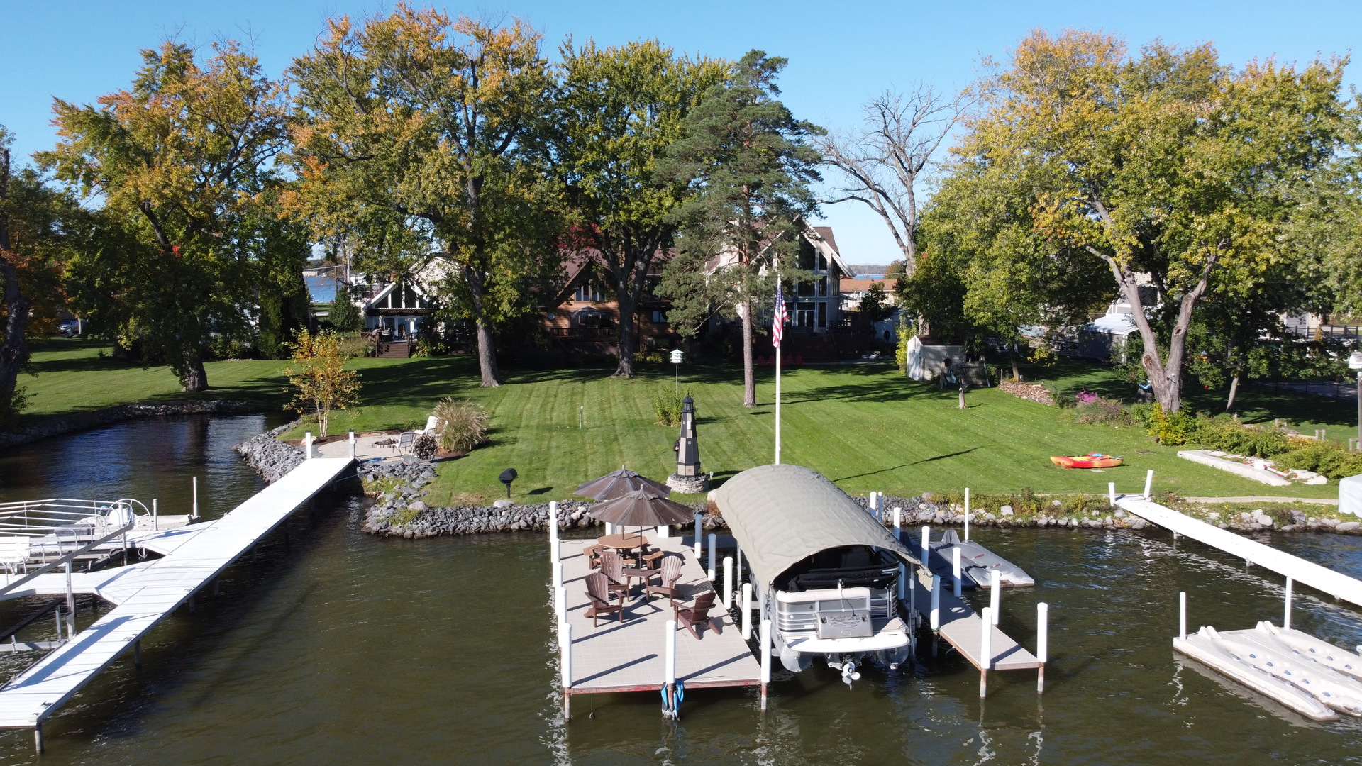 37131 North Stanton Point Road Ingleside, IL 60041 - Photo 25 of 28 a view of a lake with a bench and trees