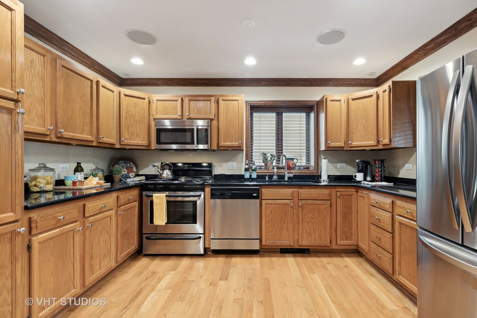37131 North Stanton Point Road Ingleside, IL 60041 - Photo 5 of 28 a kitchen with stainless steel appliances granite countertop a stove top oven a sink and dishwasher a refrigerator with wooden floors