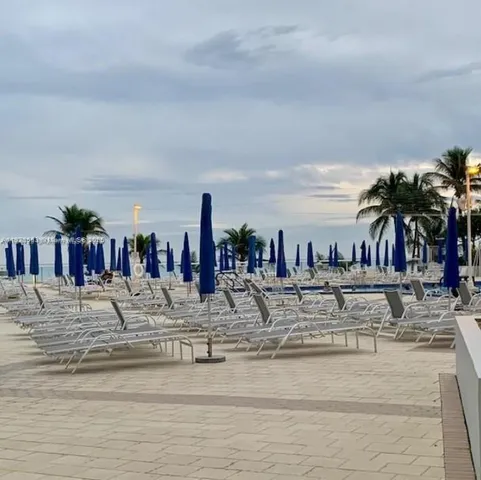 a view of a kitchen with kitchen island a large window in it