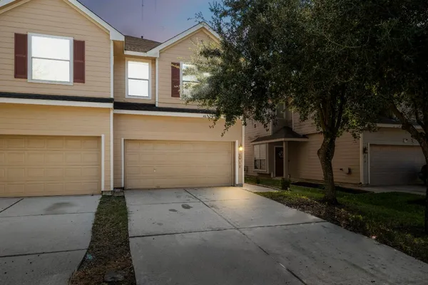 a view of backyard with potted plants and wooden fence