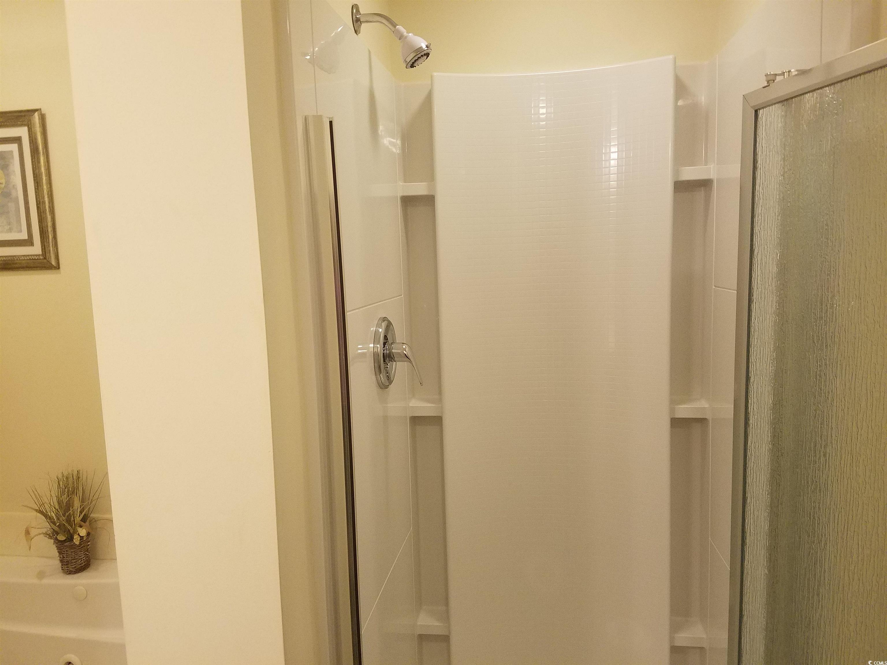 704 South Ocean Boulevard, Unit 101B Myrtle Beach, SC 29577 - Photo 11 of 25 Full bathroom with a stall shower