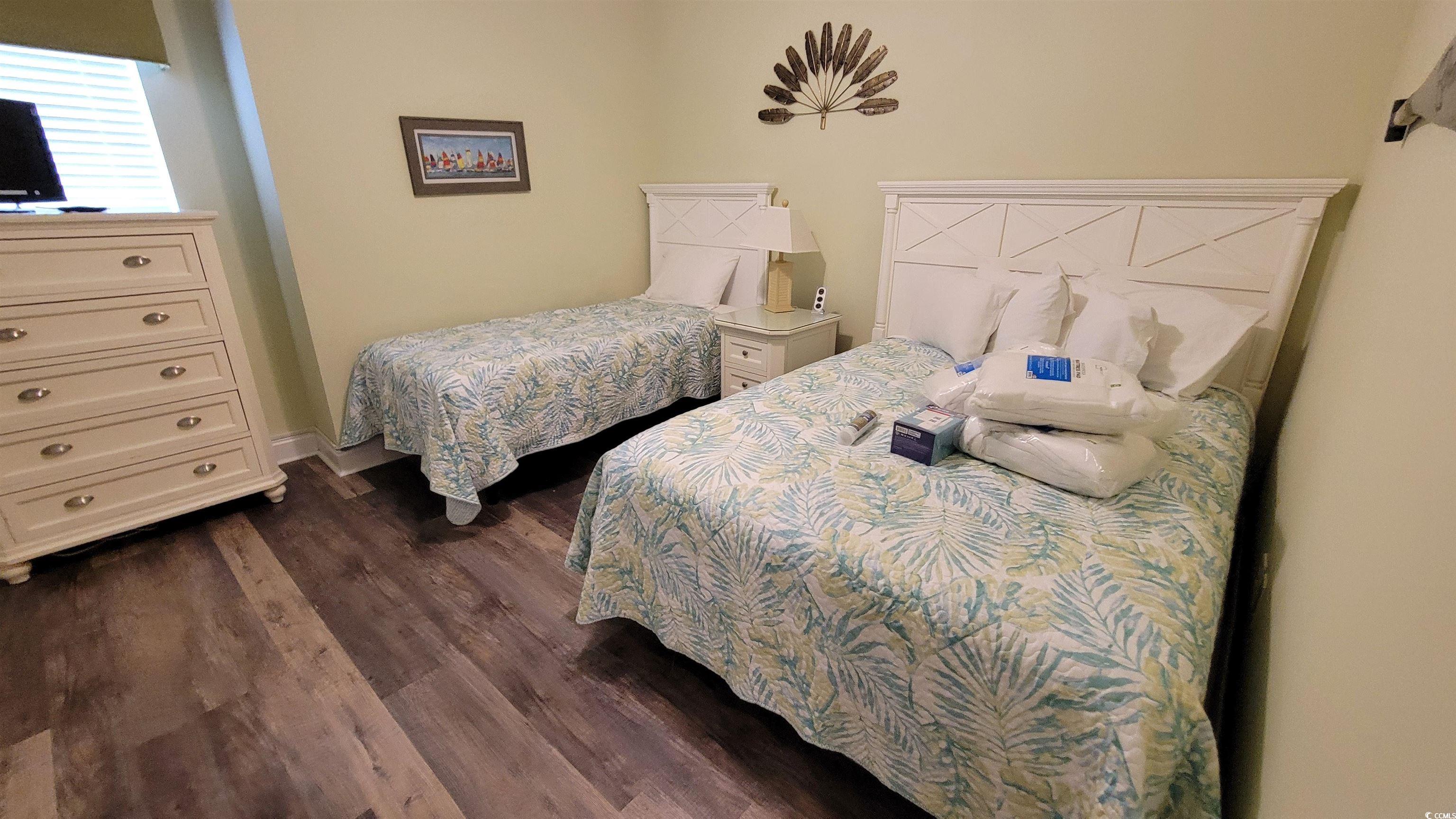 704 South Ocean Boulevard, Unit 101B Myrtle Beach, SC 29577 - Photo 17 of 25 Bedroom with dark wood-style flooring
