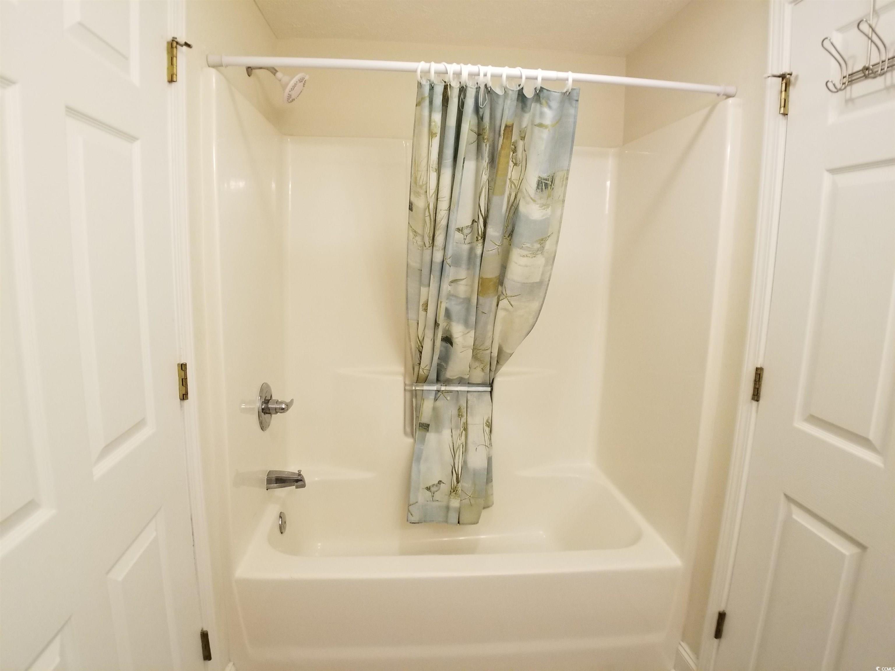 704 South Ocean Boulevard, Unit 101B Myrtle Beach, SC 29577 - Photo 18 of 25 Full bathroom with shower / tub combo with curtain