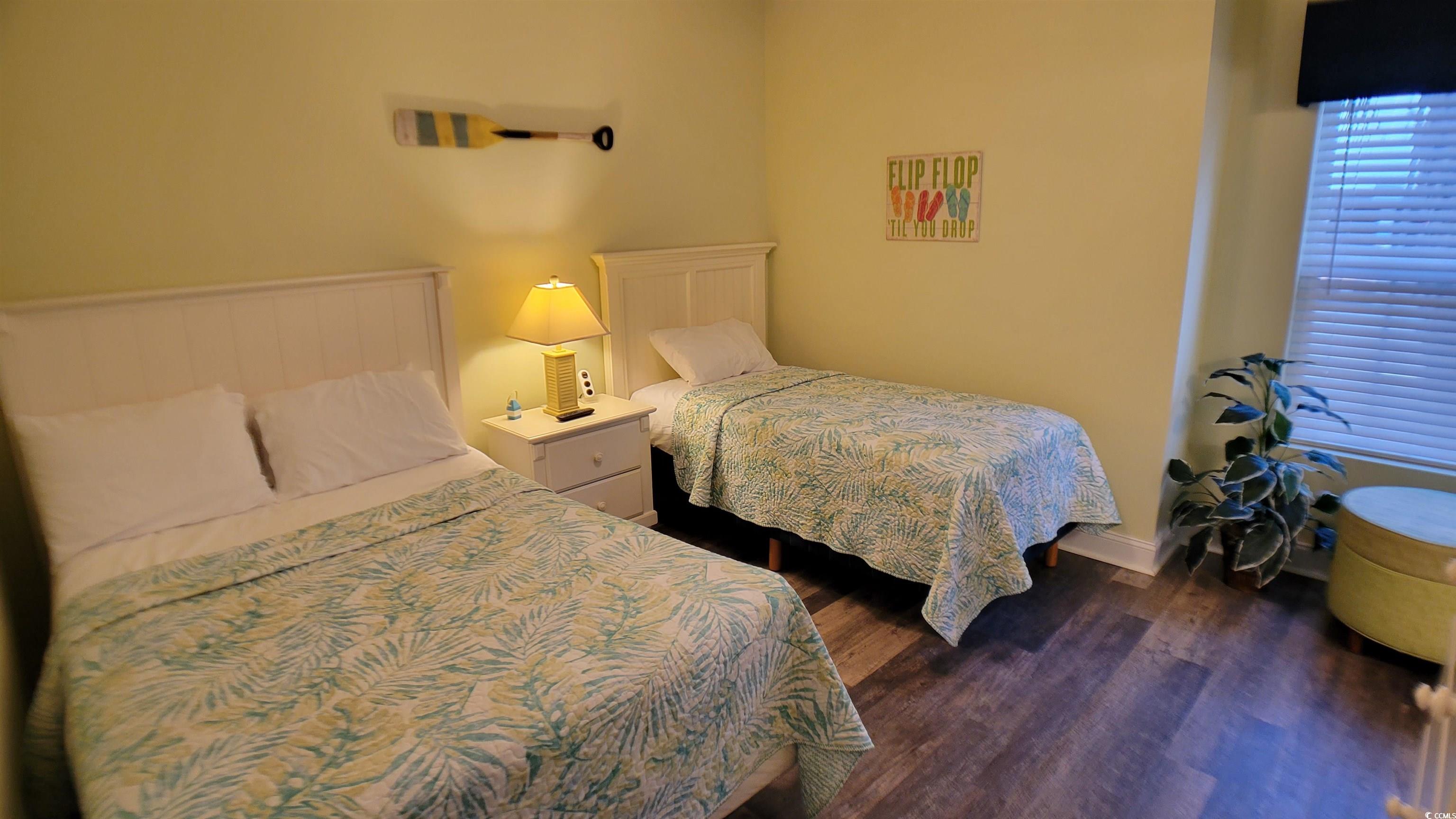 704 South Ocean Boulevard, Unit 101B Myrtle Beach, SC 29577 - Photo 19 of 25 Bedroom featuring dark wood-style flooring