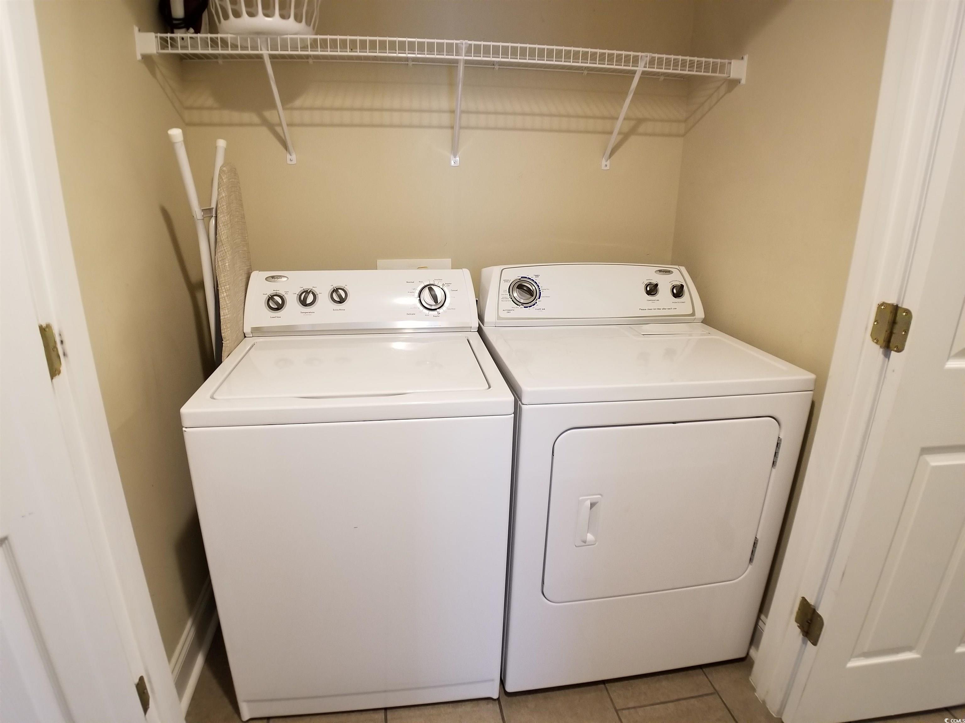704 South Ocean Boulevard, Unit 101B Myrtle Beach, SC 29577 - Photo 21 of 25 Laundry area with independent washer and dryer and light tile patterned floors