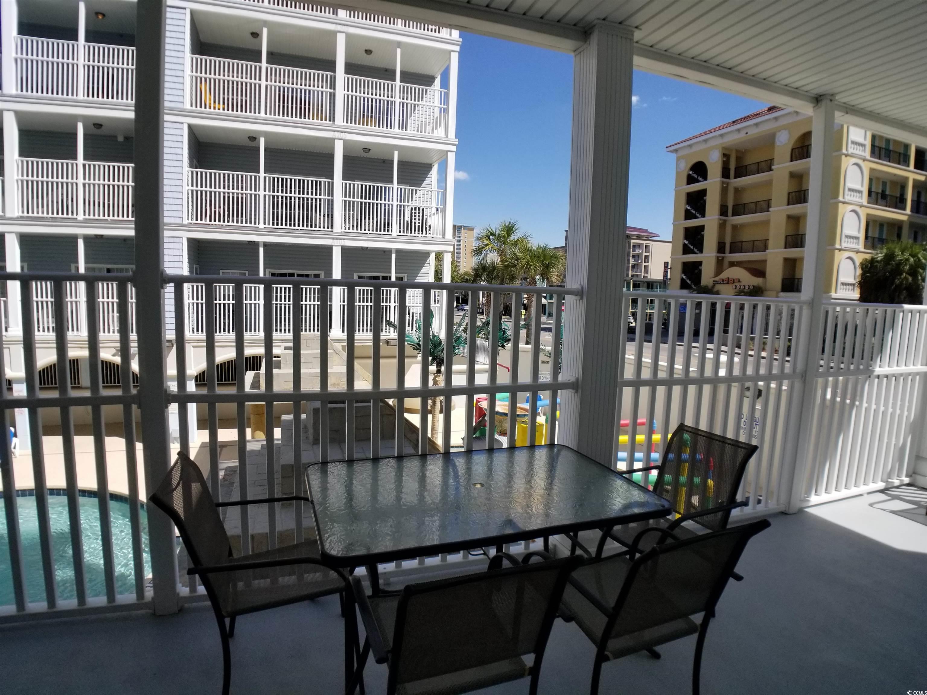 704 South Ocean Boulevard, Unit 101B Myrtle Beach, SC 29577 - Photo 22 of 25 View of patio / terrace featuring a community pool
