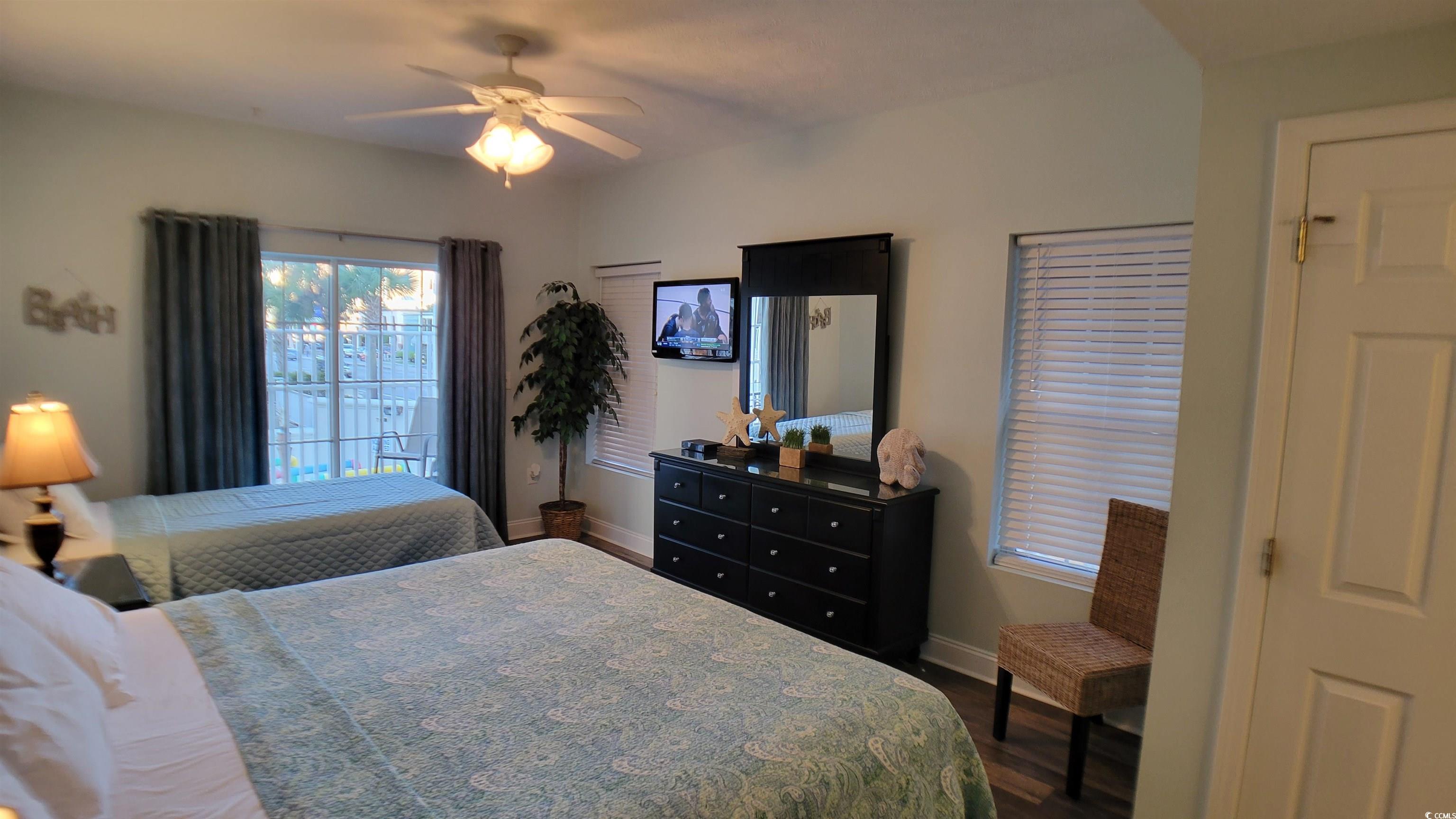 704 South Ocean Boulevard, Unit 101B Myrtle Beach, SC 29577 - Photo 7 of 25 Bedroom featuring dark wood finished floors and a ceiling fan