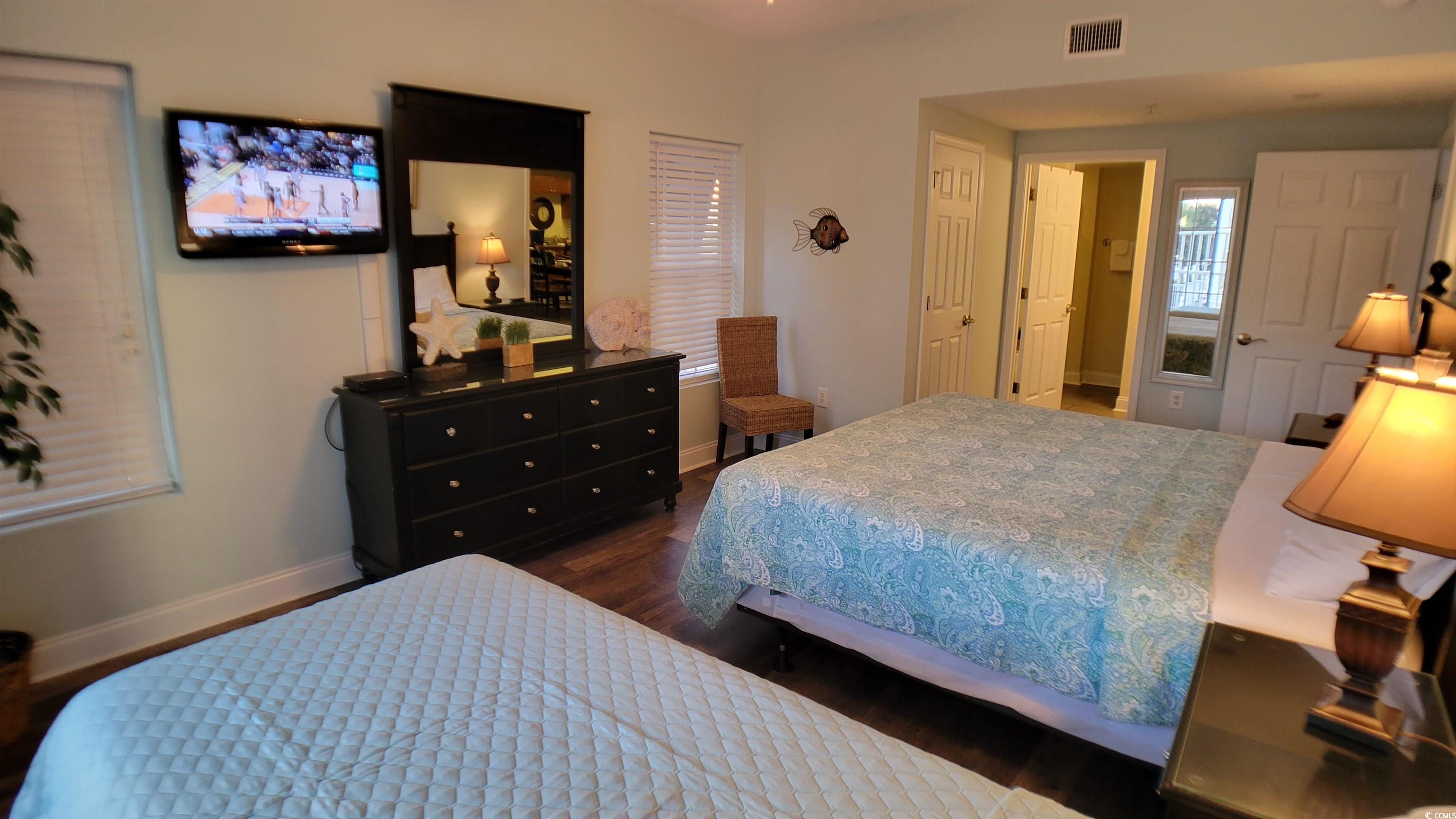 704 South Ocean Boulevard, Unit 101B Myrtle Beach, SC 29577 - Photo 8 of 25 Bedroom with baseboards and dark wood-type flooring