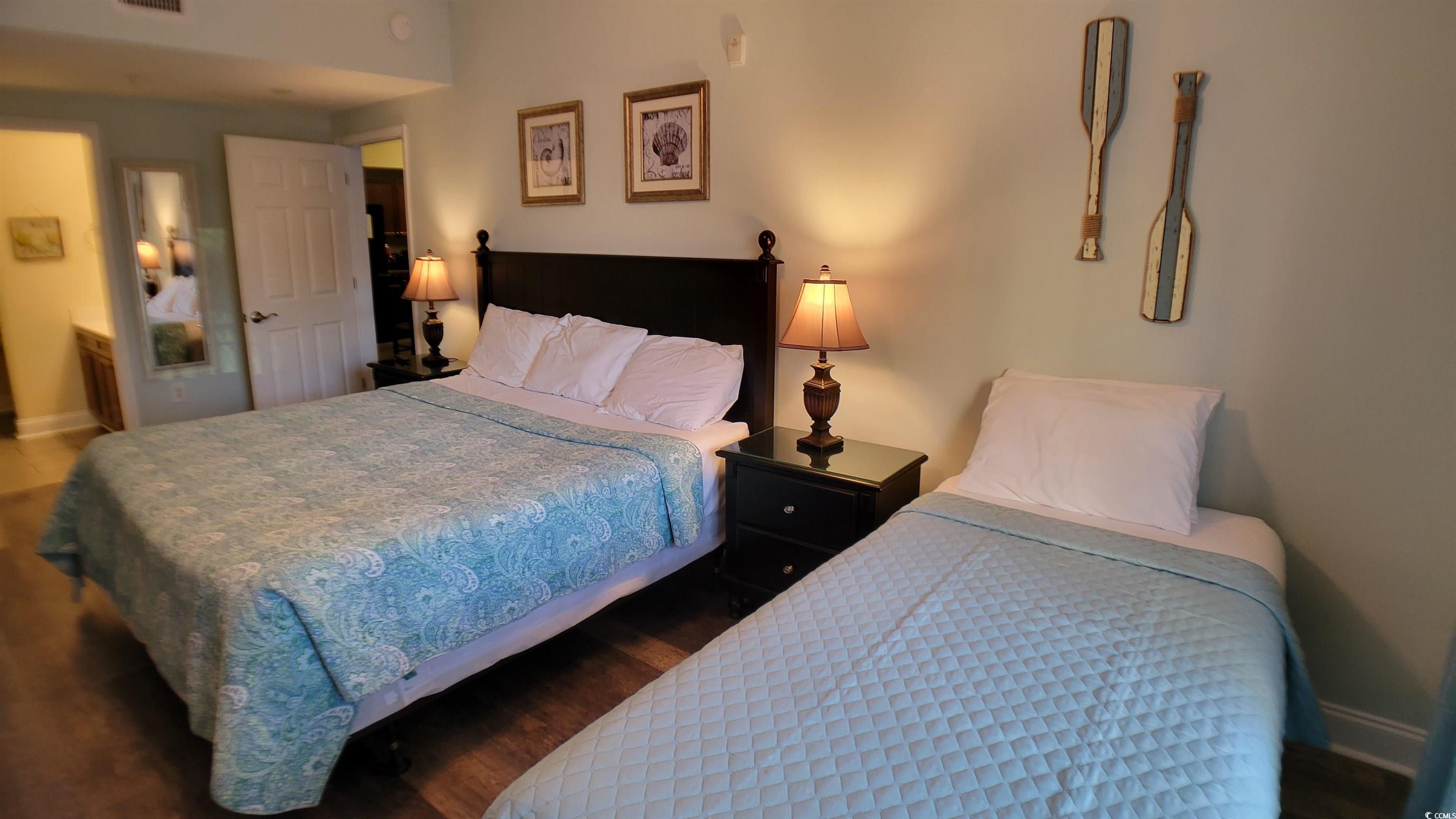 704 South Ocean Boulevard, Unit 101B Myrtle Beach, SC 29577 - Photo 9 of 25 Bedroom with wood finished floors and baseboards